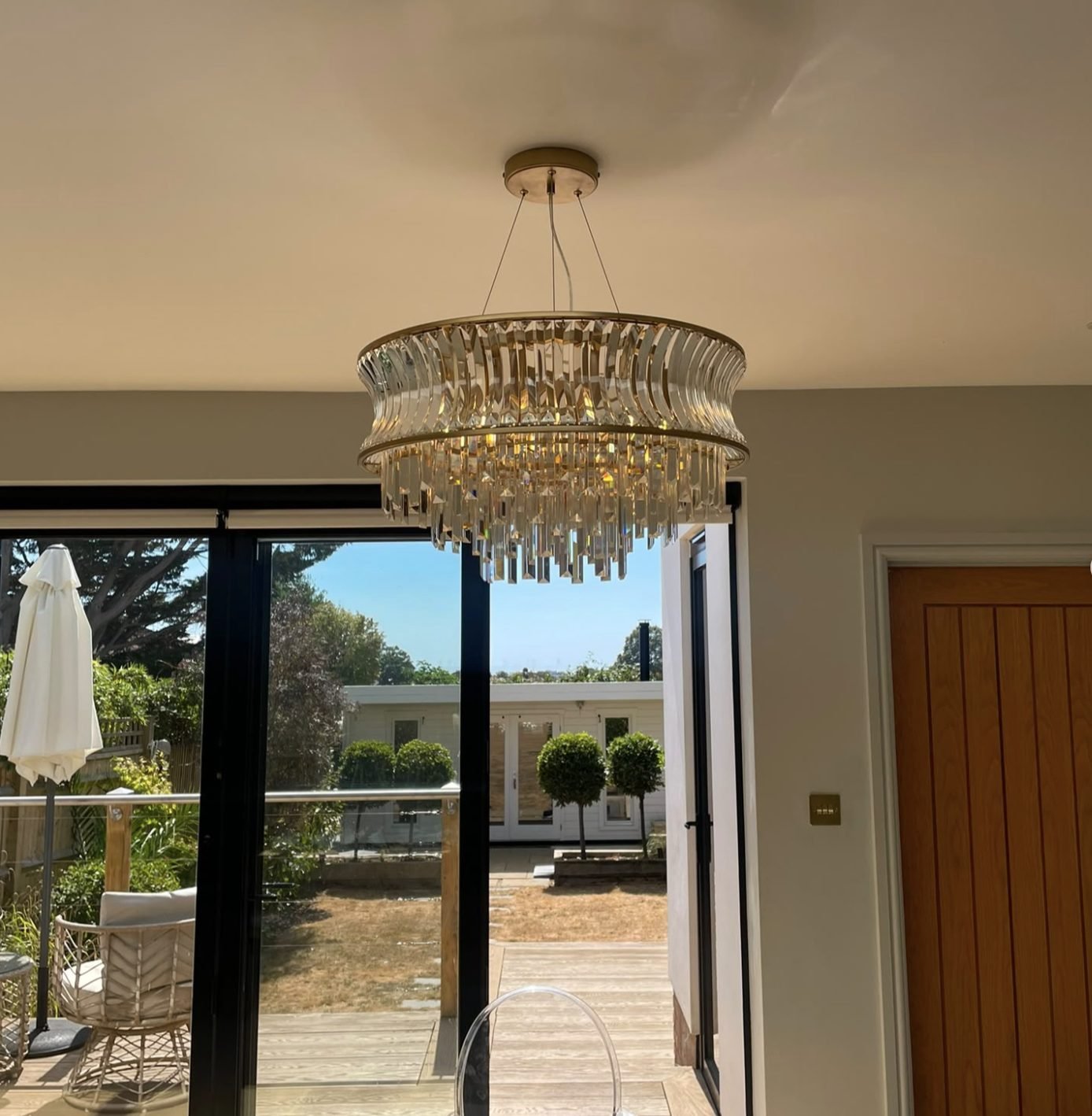 Crystal chandelier hung from a dining room ceiling