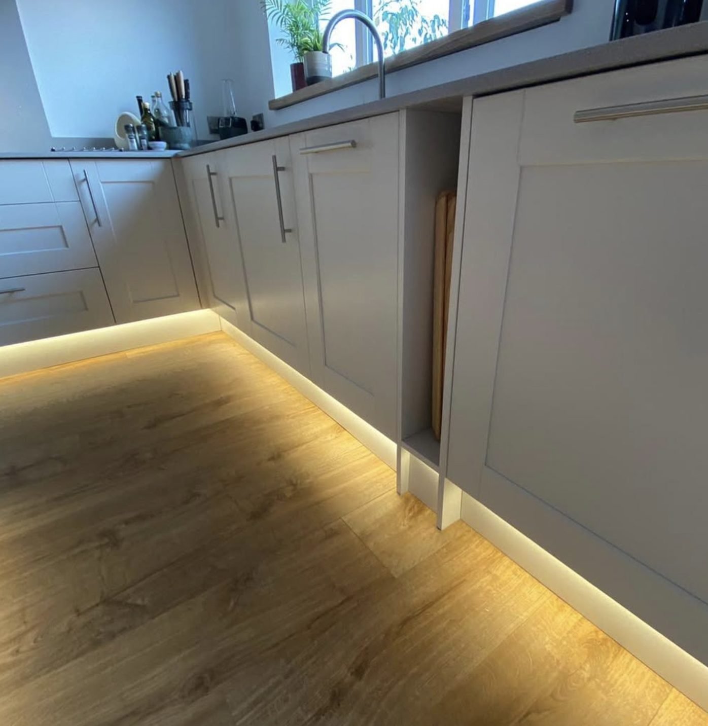 Warm LED plinth lighting under kitchen units